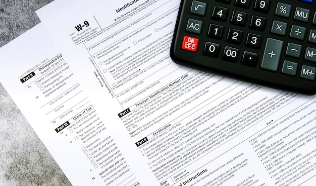 Tax relief and tax forms with a calculator to calculate taxes on a gray surface