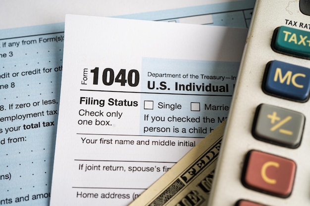 Tax Return form 1040 and dollar banknote US Individual Income