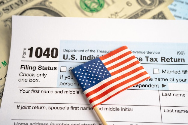 Tax Return form 1040 with USA America flag and dollar banknote US Individual Income