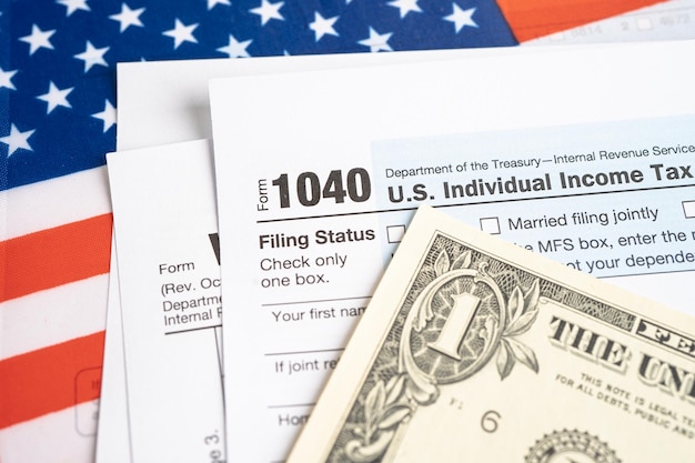 Tax Return form 1040 with USA America flag and dollar banknote US Individual Income