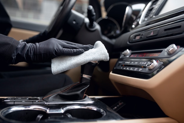 Taxi driver cleaning her car