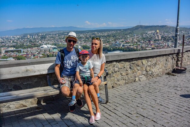 Tbilisi GeorgiaApril 28 2019 a happy family with a beautiful bird'seye view of the Central part of Tbilisi