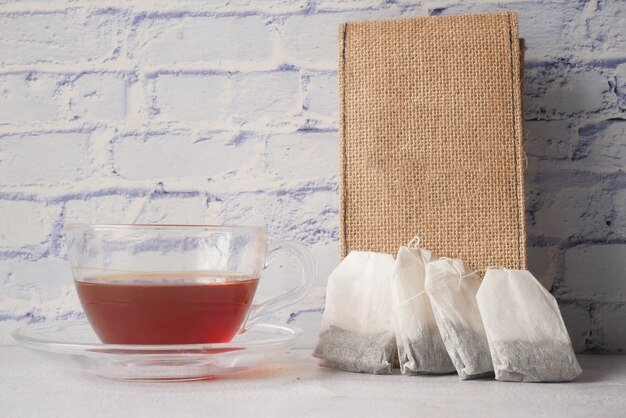 Tea bag with small bag on table close up