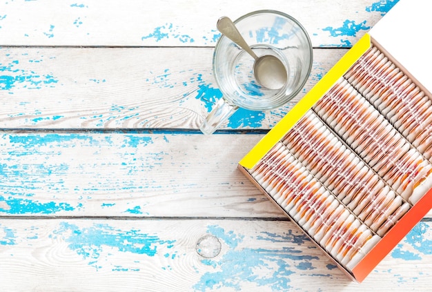 Tea bags in the box with empty cup Top view