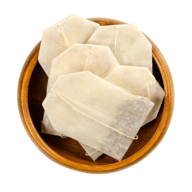 Tea bags made of filter paper in wooden bowl