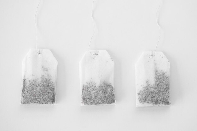 Photo tea bags on white background