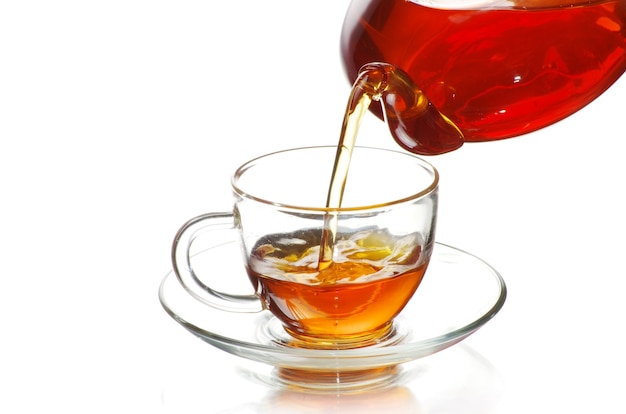 Tea being poured into glass tea cup