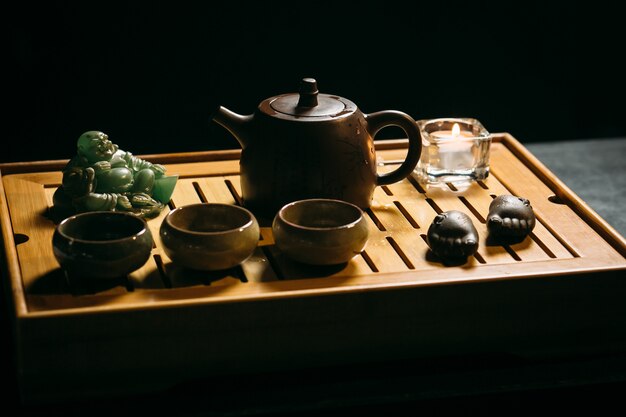 Tea ceremony. The man pours hot chinese tea into the tea cup