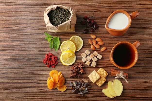 Tea composition on wooden background flat lay