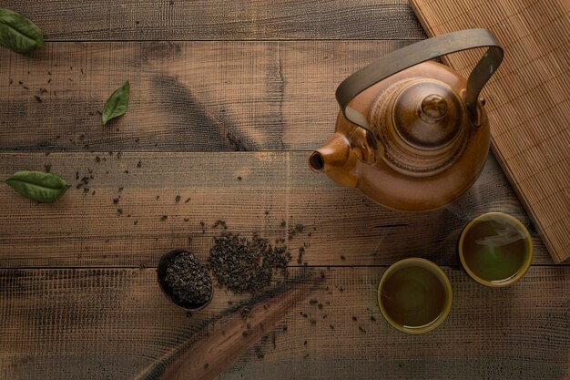 Tea concept Teapot with tea on table View from above with copy space Asian tea bowl and teapot