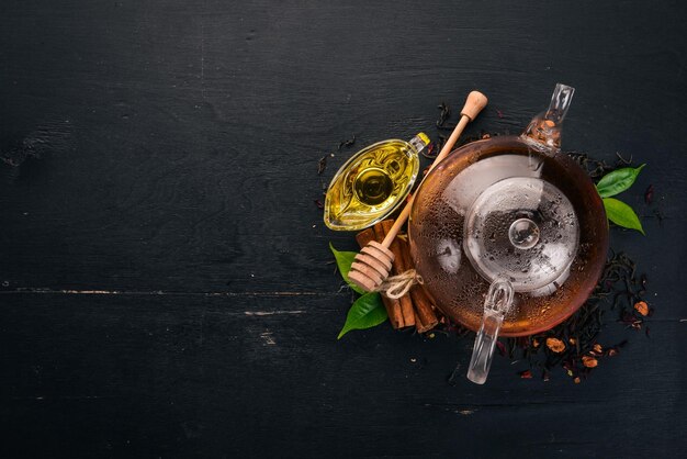 Tea in a cup of cinnamon and honey on a wooden background Hot drink Top view Copy space