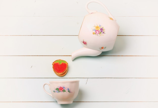 Tea cup cookies strawberries on a blue wooden background Shabby chic romantic