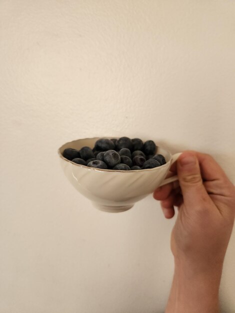 Tea cup full of blueberries