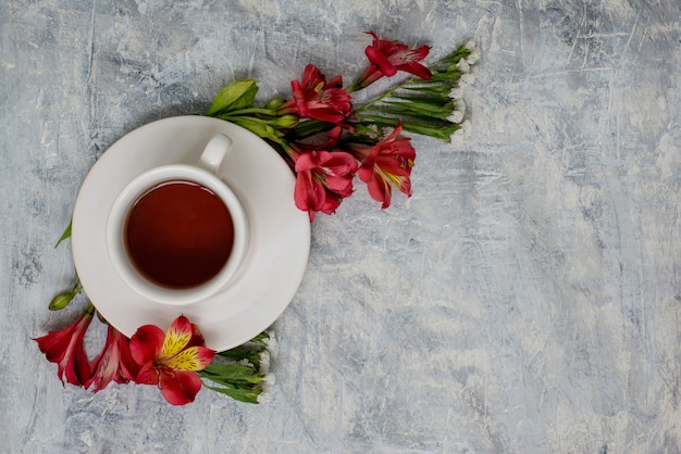 tea cup on marble table with floral arrangements