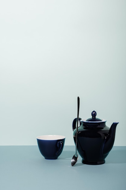 Tea cup and teapot on the table