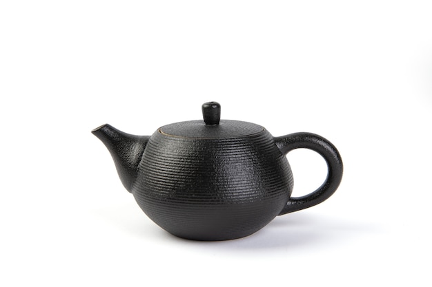 Tea in a cup and teapot on white background