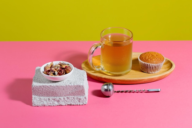 Tea in a cup with dessert on a bright colored background