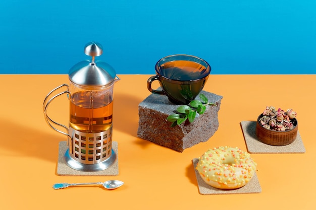 Tea in a cup with dessert on a bright colored background