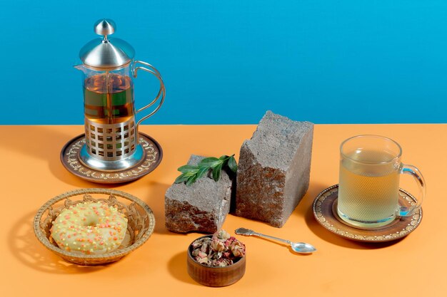 Tea in a cup with dessert on a bright colored background