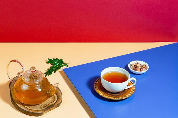 Tea in a cup with dessert on a bright colored background