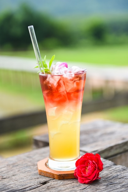 Tea flowers made from tea rose petals in a glass Iced tea with a tea rose Cold cocktail