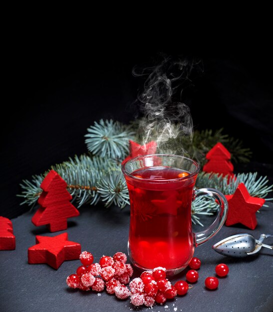 Tea from fresh red viburnum in a transparent glass 