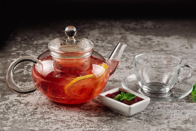 Tea from strawberry jam in a glass teapot