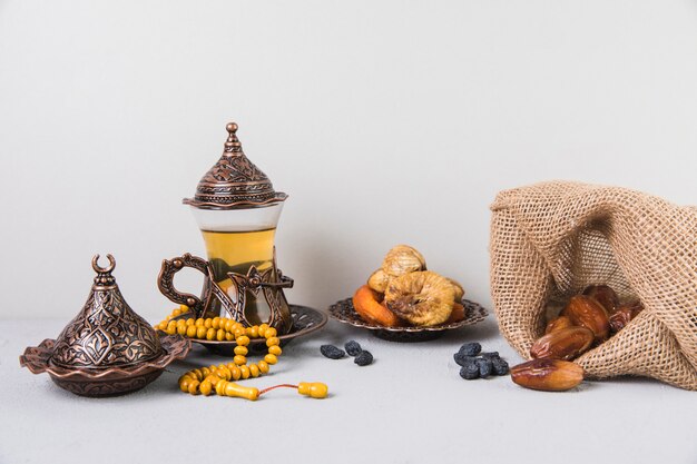 Tea glass with dried fruits and rosary beads 