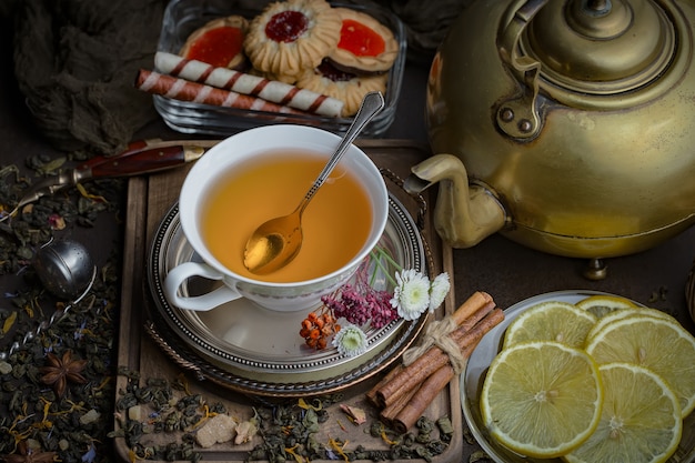 Tea hot drink on old background in composition on the table