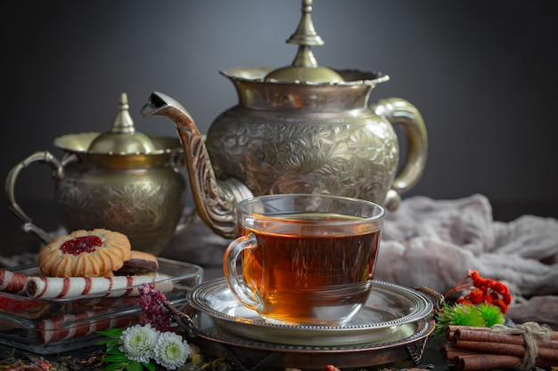 Tea hot drink on old background in composition on the table