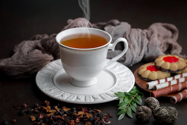 Tea hot drink on old background in composition on the table