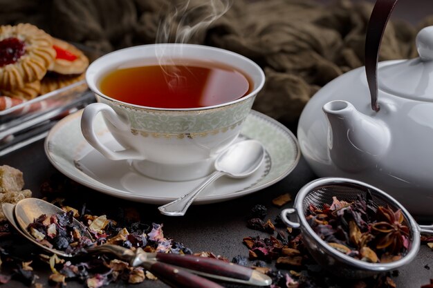 Tea hot drink on old background in composition on the table