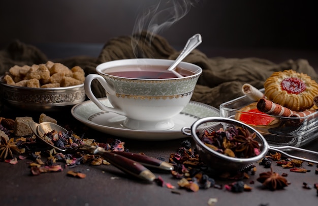 Tea hot drink on old background in composition on the table