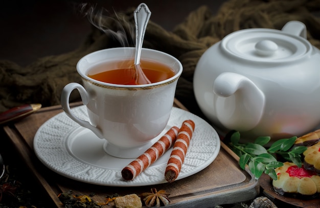 Tea hot drink on old background in composition on the table