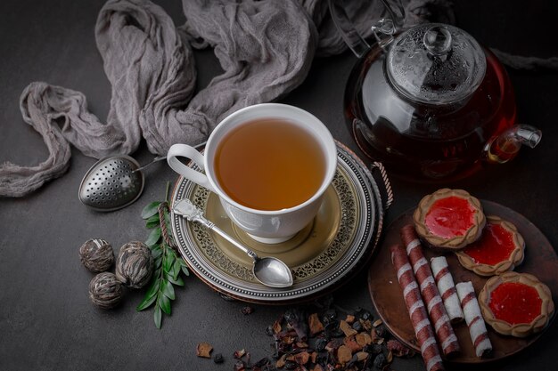 Tea hot drink on old background in composition on the table