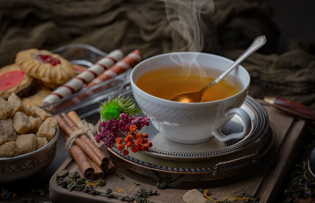 Tea hot drink on old background in composition on the table