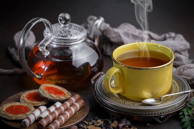 Tea hot drink on old background in composition on the table