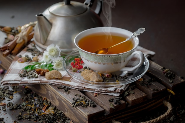 Tea hot drink on old background in composition on the table