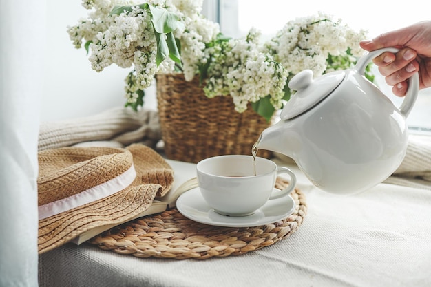 Tea is pouring into a cup from a teapot beautiful aesthetic photo