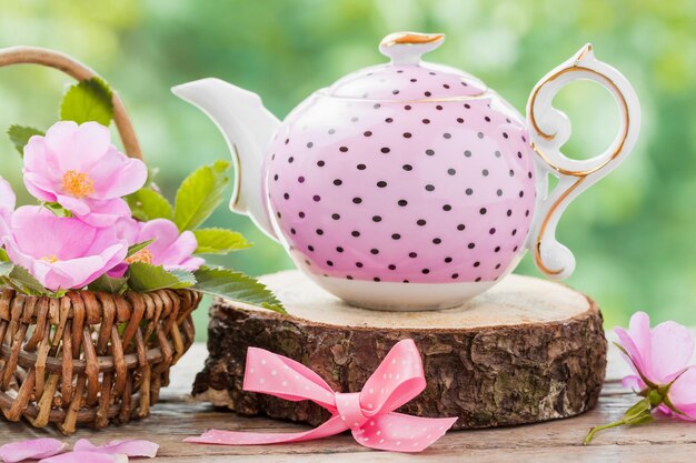 Tea kettle and basket with pink wild roses Wedding or birthday still life