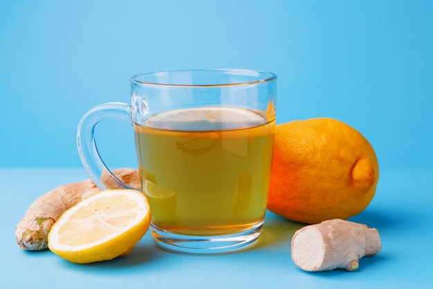 Tea, lemon and ginger on a blue