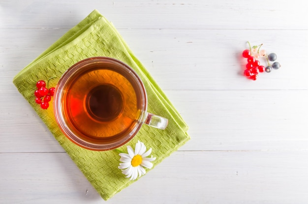 Tea in a mug with a daisy view from above on a white background with copy space