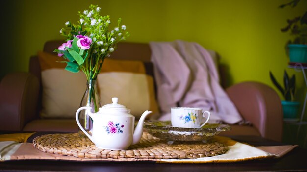 Photo tea pot flowers huge place mat crystal tray and blanket in a living room
