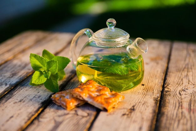 Tea pot of herbal tea on a wooden table