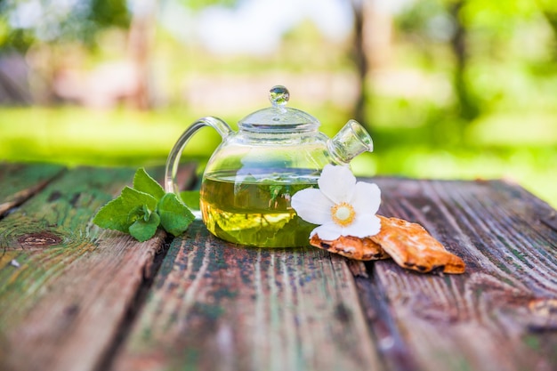 Tea pot of herbal tea on a wooden table