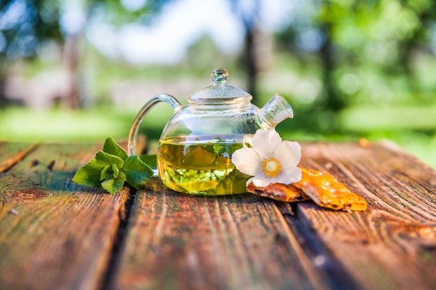 Tea pot of herbal tea on a wooden table