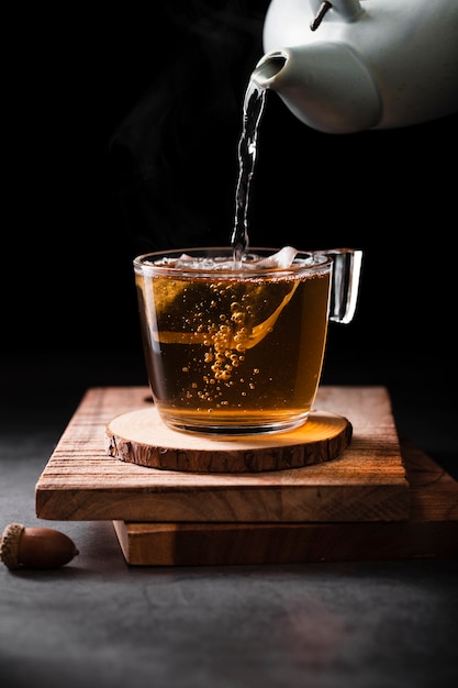 Photo tea pot pouring tea close up