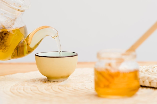 Tea poured in cup from teapot