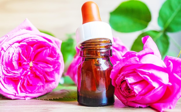 Tea rose oil in a small bottle. selective focus.