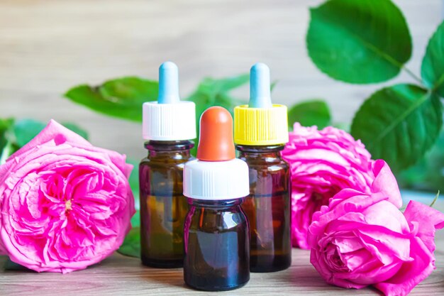 Tea rose oil in a small bottle. selective focus.